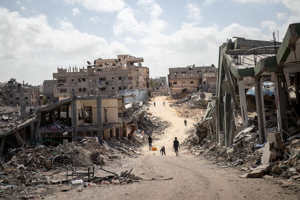 CH11031424_Children walk down the destroyed streets of Khan Younis, the Gaza Strip.jpg