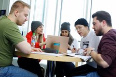 Fysiikan opiskelijoiden ryhmätyöskentelyä teknologia-avusteisessa oppimisympäristössä. Eetu Räsänen (vas.), Henna Kokkonen, Philson Aden, Emmi Rajala ja Samuli Aalto ryhmätöissä fysiikan laitoksella. (Kuvaaja: Petteri Kivimäki)