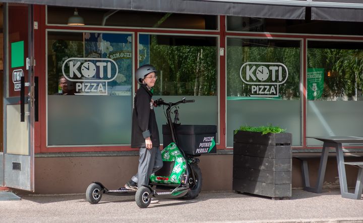 Kotipizza aloittaa pilotoimaan sähköpotkukelkkojen käyttöä pizzojen kotiinkuljetuksissa. Kuvassa Kotipizzatyöntekijä Aino. Kuva: Arctic Rides.