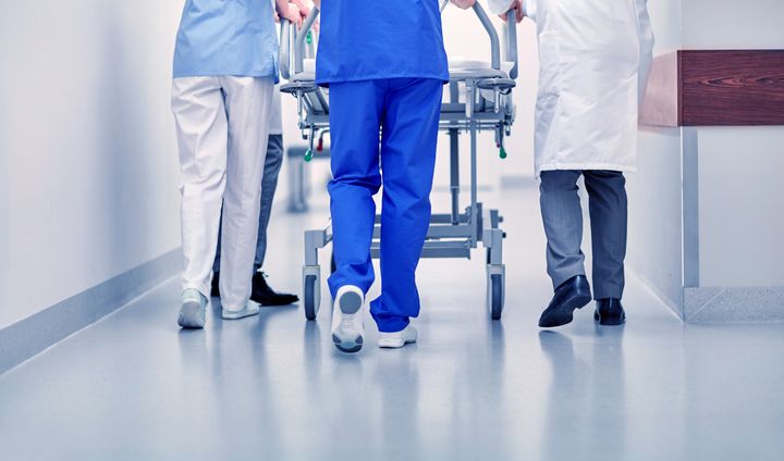 Kuvituskuva, terveydenhoitoalan ammattilaiset kävelevät käytävällä. Kuva: Mostphotos