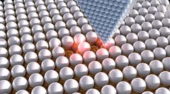 Tunnelointimikroskoopin (STM) kärki tarkoituksella liikutettujen klooriatomien yllä. Tutkijat ovat onnistuneet yksittäisiä atomeja liikuttamalla järjestämään vakansseja yhdessä klooriatomikerroksessa. Samalla tavoin he ovat myös luoneet atomihiloja, joilla on ennalta määritelty sähkövaste. Kuva Ella Maru Studio.