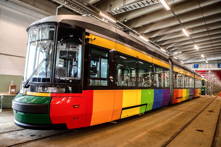 Sateenkaaren väriseksi teipattu raitiovaunu raitiovaunuhallissa.
