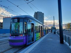 Raitiovaunu pysäkillä aamuhämärässä.