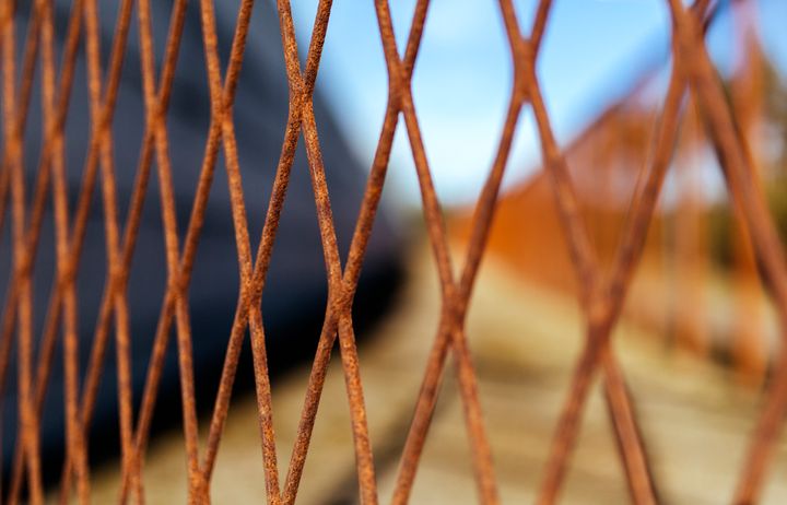 Metallinen ristikko, jonka takana tyhjä alue.