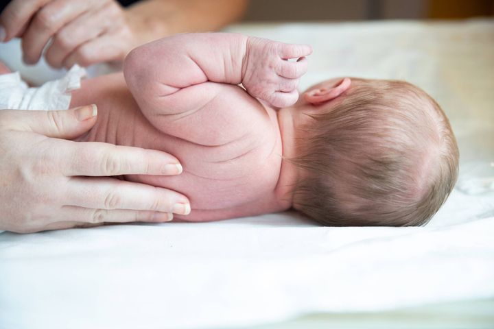 Newborn baby on a changing table.