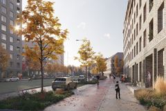 Kadun varrella uusia ruskeatiilisiä taloja, pysäköityjä autoja, puita ja istutuksia sekä jalankulkijoita.