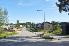 A street with detached houses on both sides.