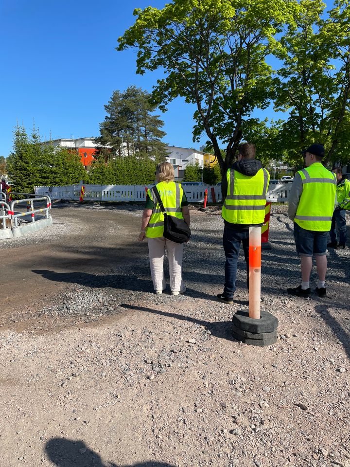 People with working clothes at the street site.