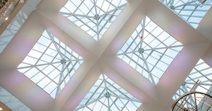 Näkyy kauppakeskuksen katto, jossa on lasikatto ja ristikkorakenne.