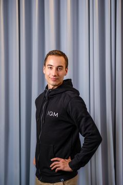 Eric Hyyppä in front of a grey curtain.