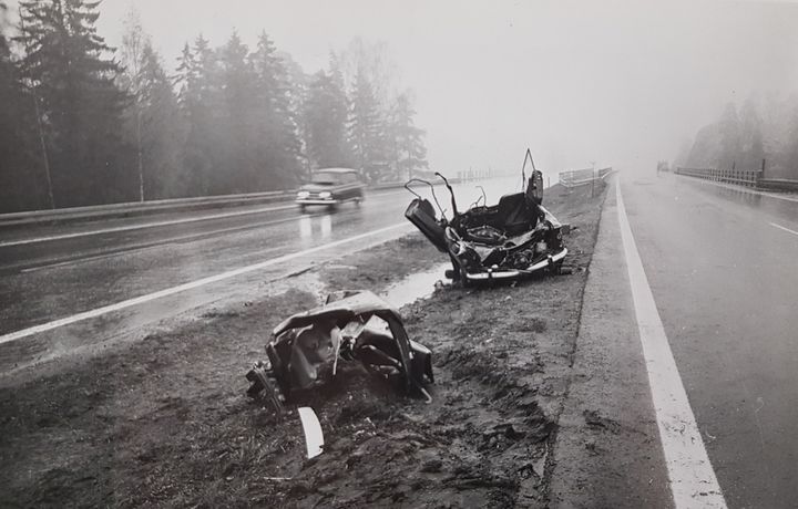 Mustavalkoinen kuva auto-onnettomuuden jäljistä maantiellä.
