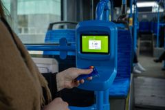 Matkustaja ostaa bussissa kertalipun maksukortin lähimaksulla lukijalaitteelta.