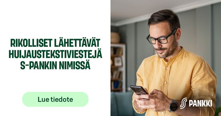 Henkilö käyttää älypuhelinta sisätiloissa