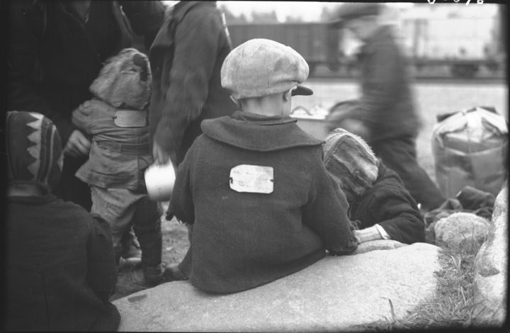 Mustavalkoisessa kuvassa pakolaislapsia syksyllä 1944. Mukana on matkatavaroita ja taustalla näkyy junavaunu.
