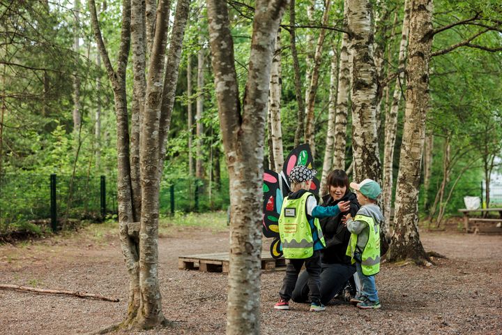 Adult and children outdoors.
