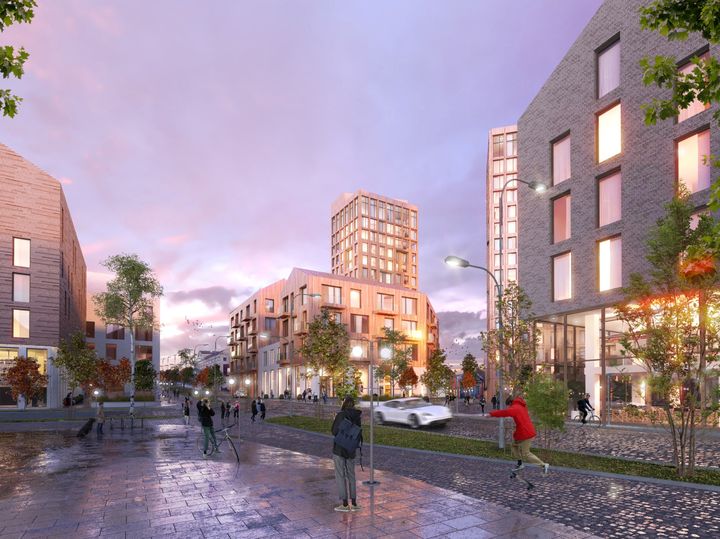 Havainnekuva modernista kaupunkikorttelista, jossa näkyy useita korkeita rakennuksia, puita ja ihmisiä kävelemässä märällä päällystetyllä kadulla iltavalossa.