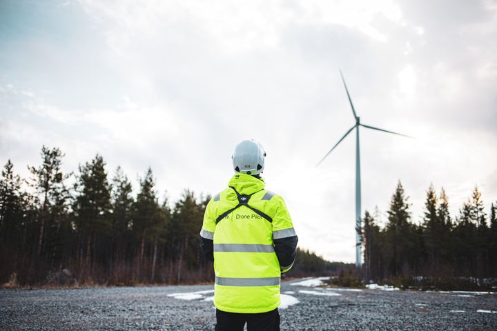 A drone pilot from Starsview inspects a wind tubine with a drone