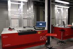 Automaattinen keräilyjärjestelmä, jossa punaisia robotteja ja tietokonenäyttö.