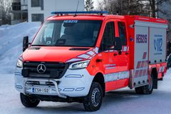 Punainen pelastusajoneuvo lumisessa ympäristössä.