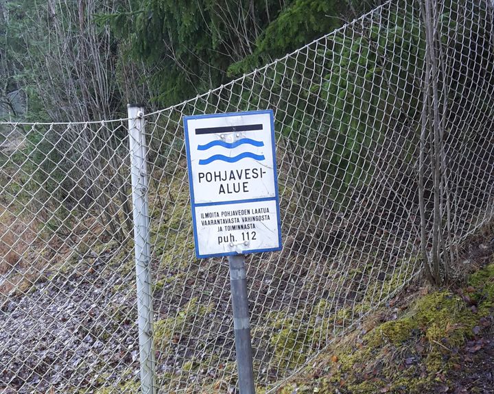 Pohjavesialue-kyltti maastossa.