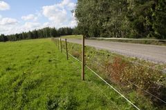 Sähköistetty petoaita hiekkatien laidassa