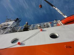 The side of Aranda  photographed looking up from small rubber boat alongside.
