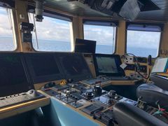 Interior view of the R/V Aranda's bridge, showing navigation equipment and windows overlooking the sea.