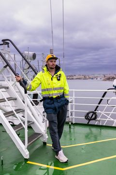 Researcher Okko Outinen standing on-board research vessel Aranda.