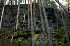 Kuva kalliomaisemasta, jota ympäröi metsän puita.