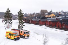 Ambulanssi ja paloauto talvella Porvoonjoen rannalla taustalla Vanhan Porvoon aitat.