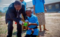 Catherin, 13, plants a tree in her home village of Kilosa together with Nobert Mbwillon, General Secretary of the Morogoro Diocese of the Lutheran Church in Tanzania.