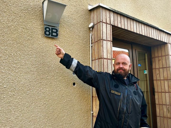 Johtava palotarkastaja Jarkko Jääskeläinen osoittaa talon seinässä olevaa numerointia.