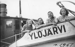 Neljä henkilöä seisoo hymyillen Ylöjärvi-laivan reunalla vuonna 1951.