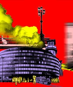 Valokuva, jossa punaisella taustalla iso pyörä rakennus ja korkea torni.