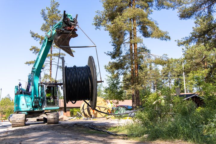 Maakaapelia laitetaan ojaan. Kuvituskuva.