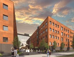 Rakennusten muodostama moderni kampusalue, jossa on oransseja seinäpaneeleja. Rakennusten välissä on lasinen sisäänkäynti. Etualalla ihmisiä kävelee pihalla iltataivaan alla.