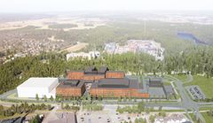Ilmakuva rakennuskompleksista, jota ympäröi metsä ja pienempiä rakennuksia.