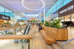 Kauppakeskus Jumbon viihtyisän keskusaukion puisia oleskelualueen penkkejä ja viherkasveja.