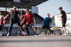 A group of people playing basketball.