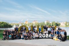 Group photo of the European Capitals of Culture network with the "Oulu 2026" sign in the background.