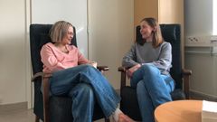 Två personer sitter och ler åt varandra.