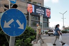 Pedestrians walk past an advertisement featuring Israel's Prime Minister Benjamin Netanyahu (R) of the Likud party and the country's former chief of the general staff and leader of the Yasher centrist political party Gadi Eisenkot, along a street in Ramat Gan on September 23, 2026. Israel heads to the polls on October 27 in its first election since the October 7, 2023, Hamas-led attack, in what is seen as a referendum on Netanyahu.