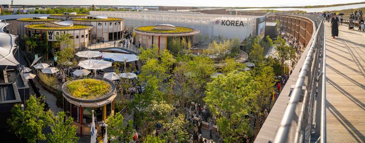 View of the German Pavilion at Expo Osaka, with the iconic ring structure in the background.