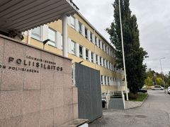 Vaalea, kolmikerroksinen rakennus, jossa lukee "Lounais-Suomen poliisilaitos". Ulkona kasvaa iso puu.