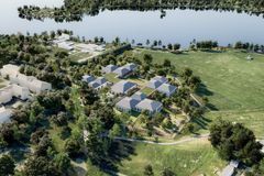 Ilmakuva alueesta, jossa uudisrakennuksia ja ympäröivää luontoa.