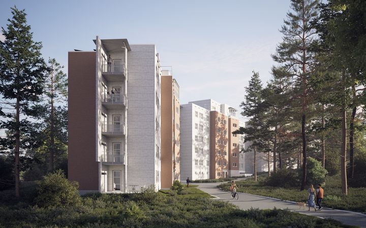 Kaksi kerrostaloa metsän reunassa. Kävelytie kulkee rakennusten ohi, jossa ihmiset kävelevät ja pyöräilevät.