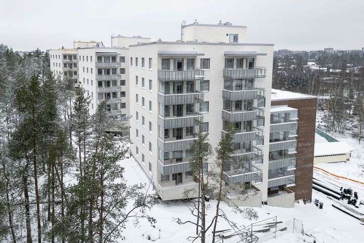 Kerrostalo talvimaisemassa. Rakenteilla oleva rakennus Gräsanportti 2 Espoon Olarissa.