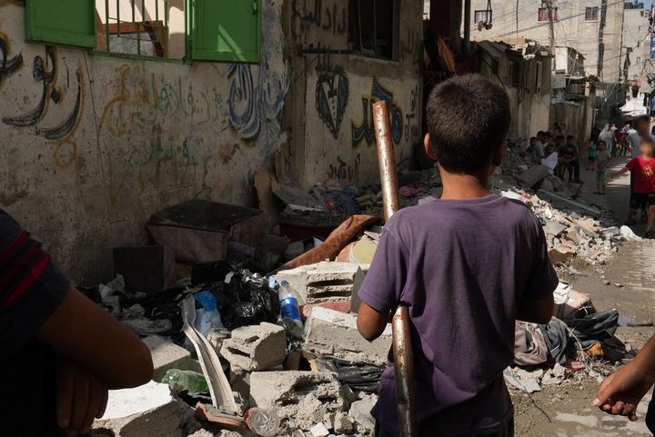 Lapsi seisoo Gazan kadulla raunioiden keskellä. Sota alkoi 7. lokakuuta 2023 ja sodan aikana henkensä on menettänyt yli 21 000 lasta.