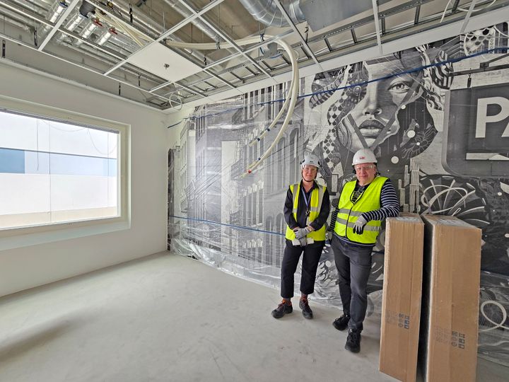 Nina ja Jarmo poseeraavat keskeneräisessä huoneessa rakenteilla olevassa tilassa.