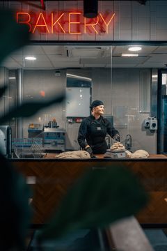 Friends & Brgrsin työntekijä työskentelee avoimessa leipomossa ravintolasalin takana.